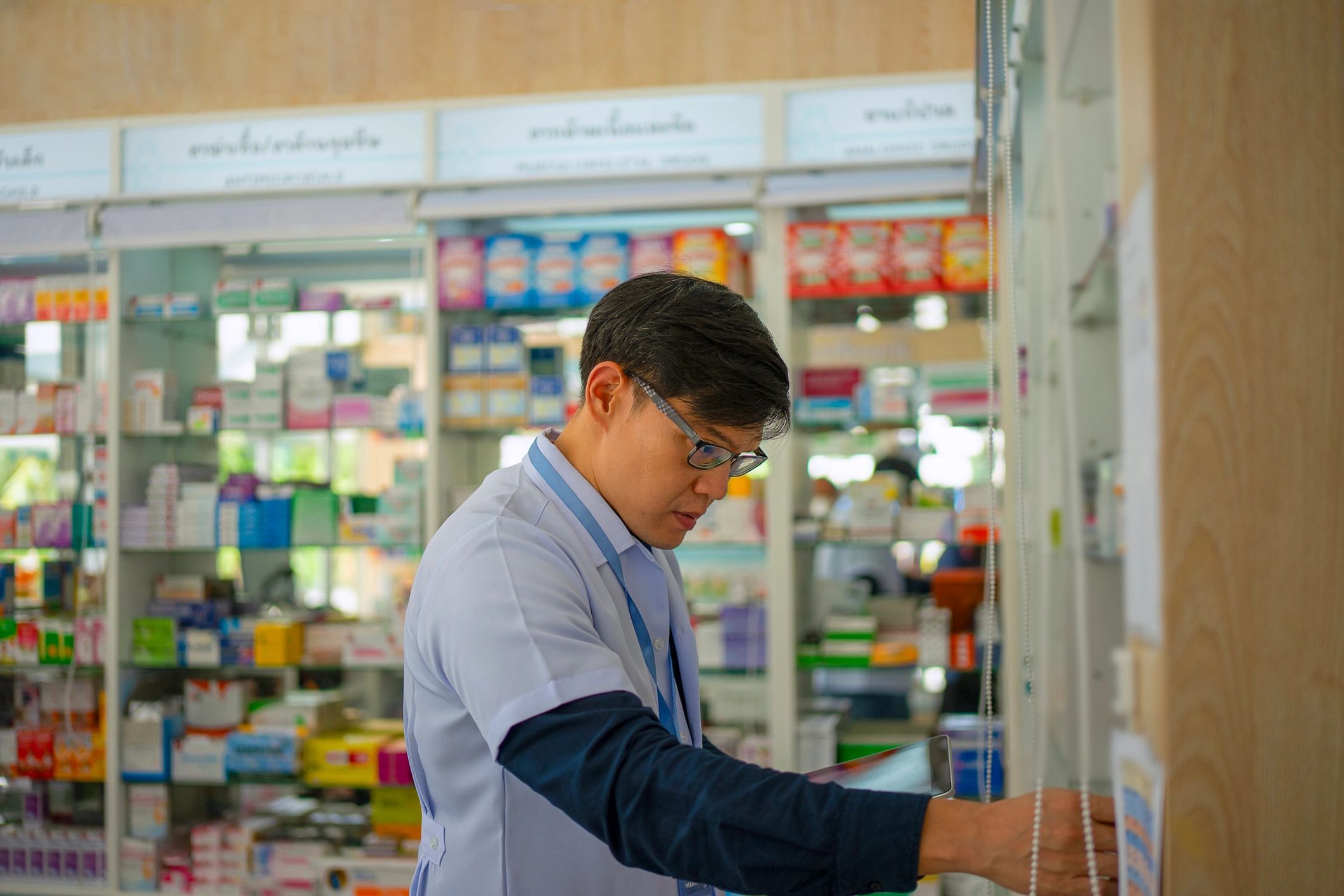 Pharmacist working inside a pharmacy store