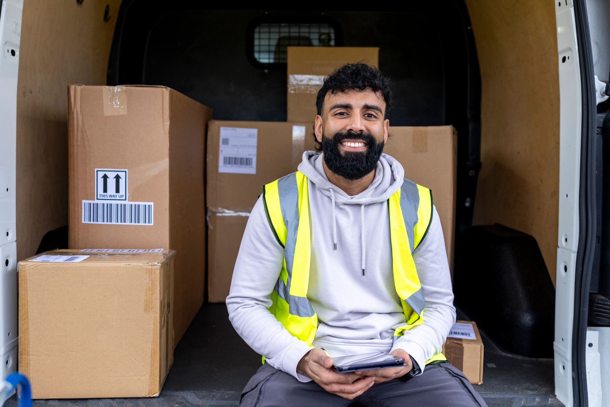 Professional courier in delivery van coordinating healthcare logistics