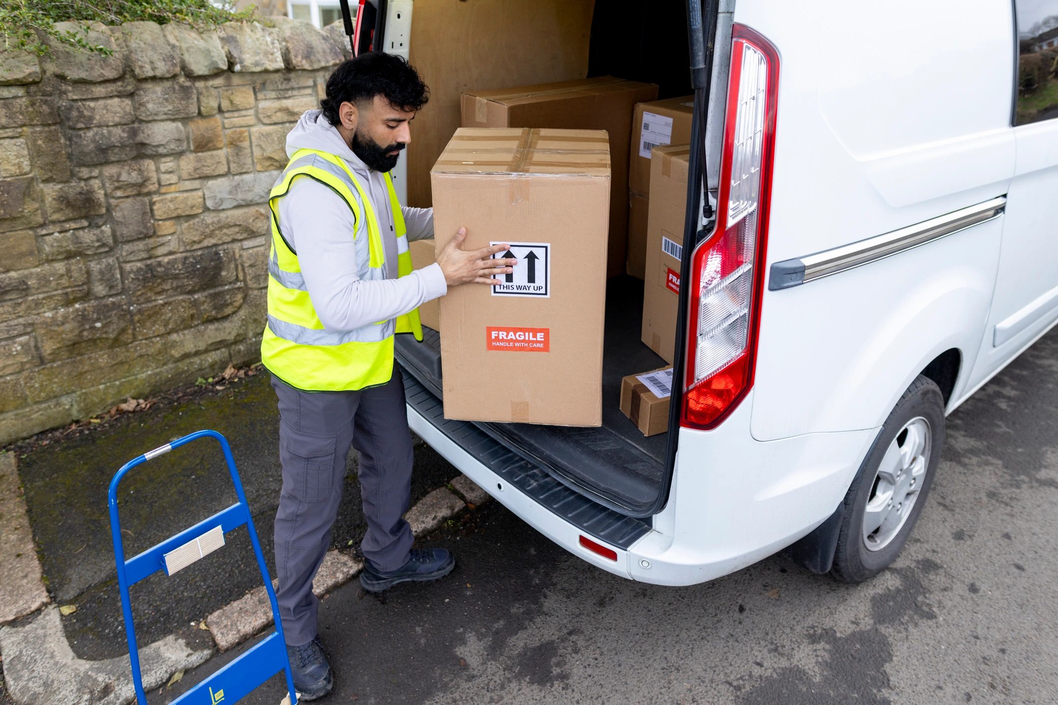 Courier unloading items from a delivery van
