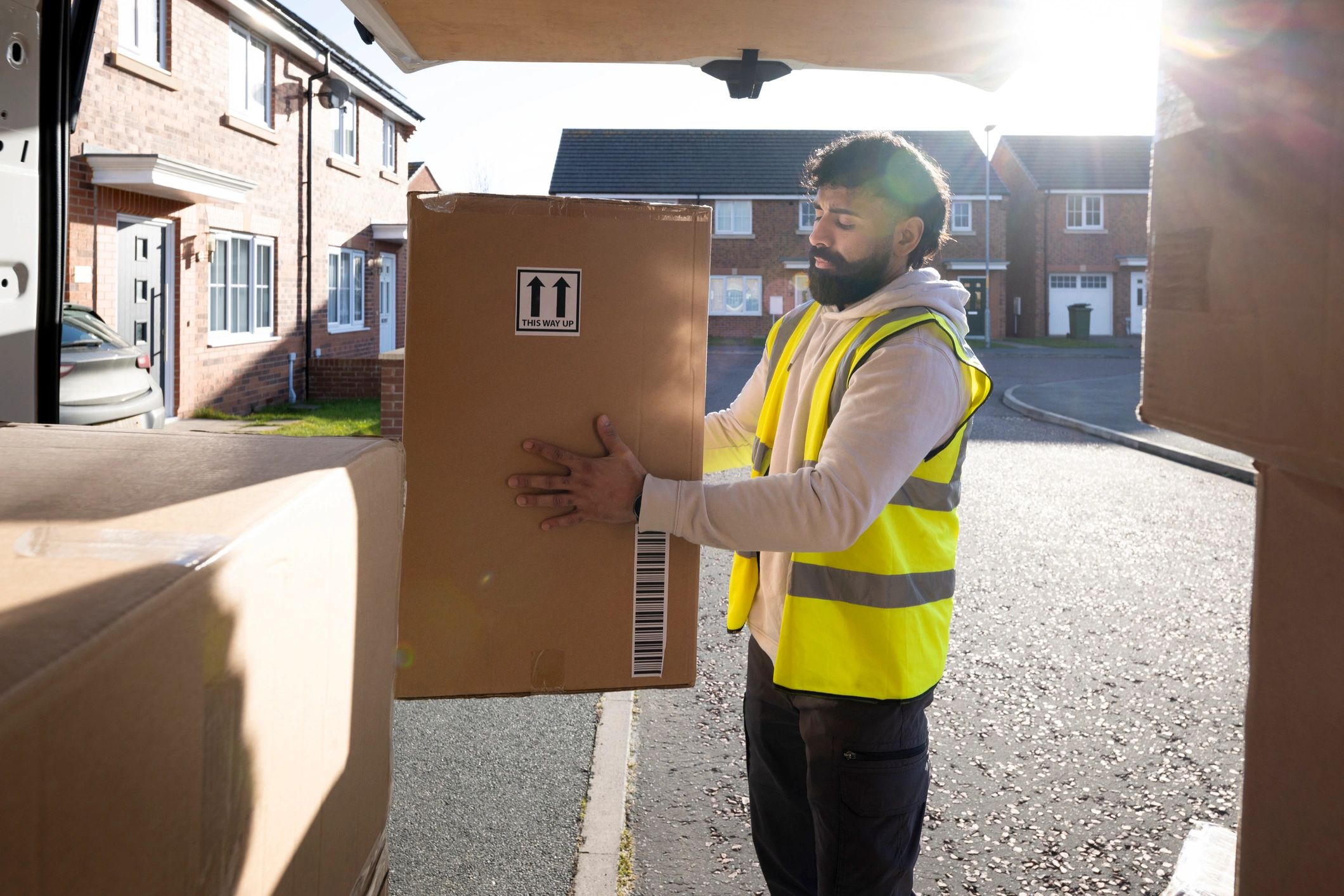Courier unloading medical delivery packages from a van
