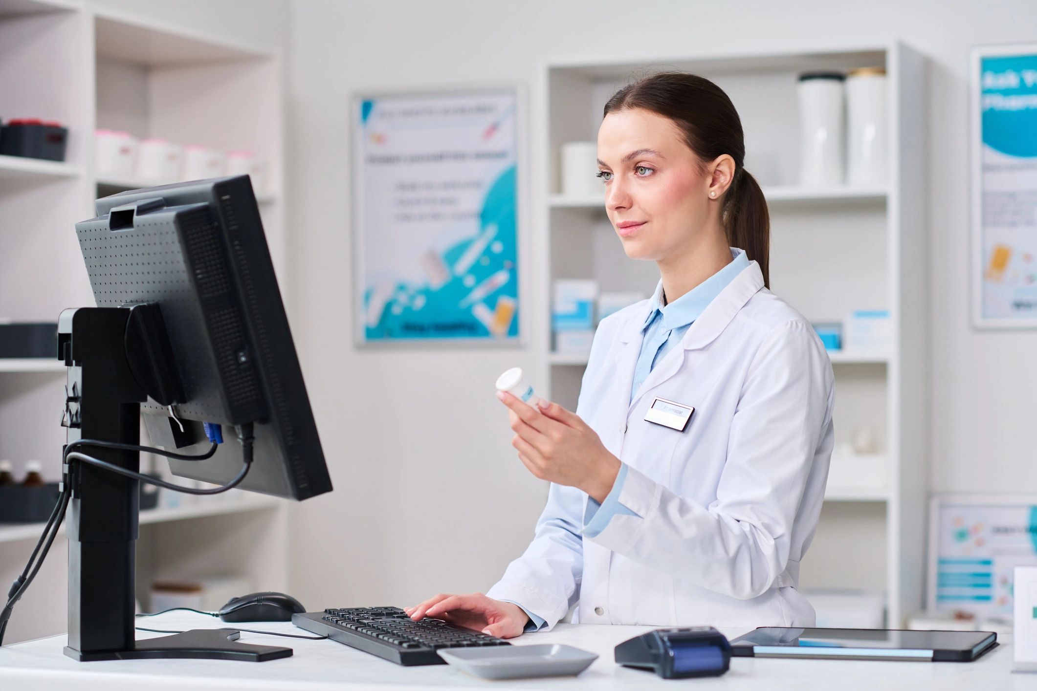 Pharmacist checking prescription medication at a pharmacy counter