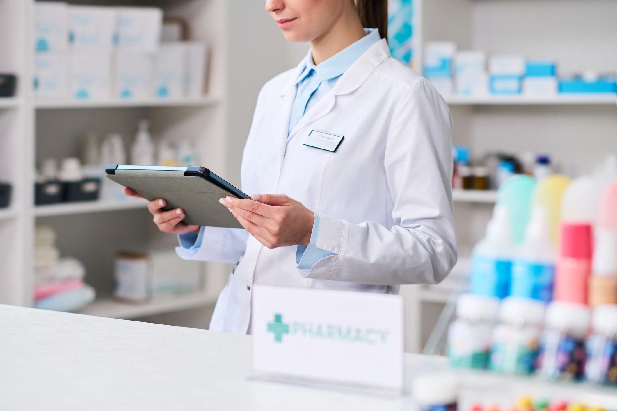 Healthcare professional managing pharmacy workflow for urgent prescription coordination